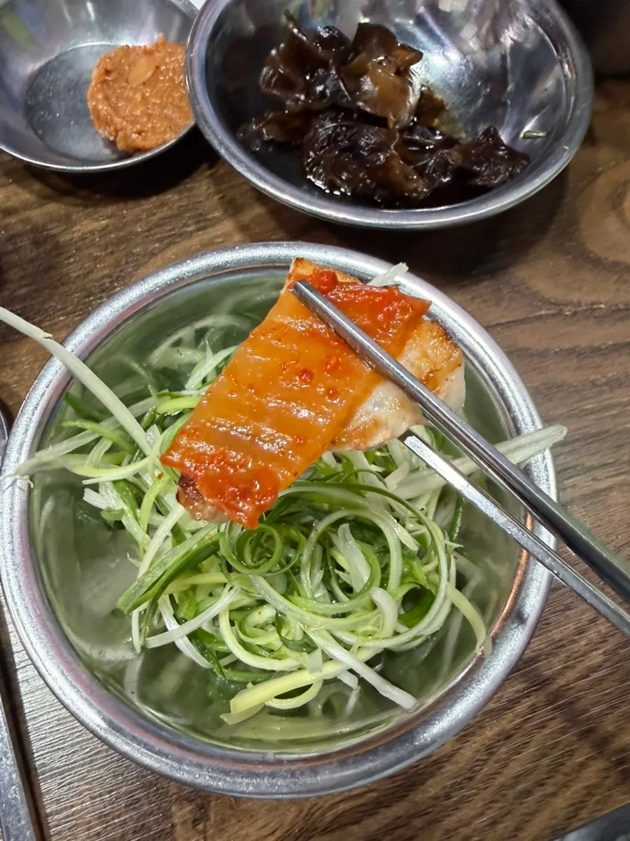 Pork belly being grilled tableside