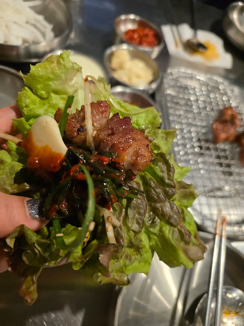 Lettuce wrap with marinated ribs, scallion salad, and garlic