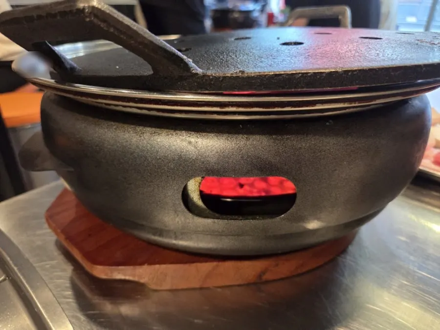 Briquette cast-iron grill set on the table