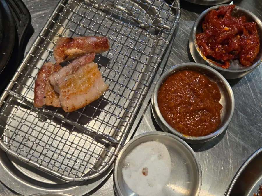 Grilled meat pulled to the side of the pan