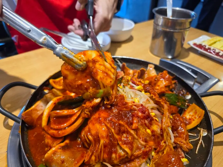 Cutting the kimchi with scissors