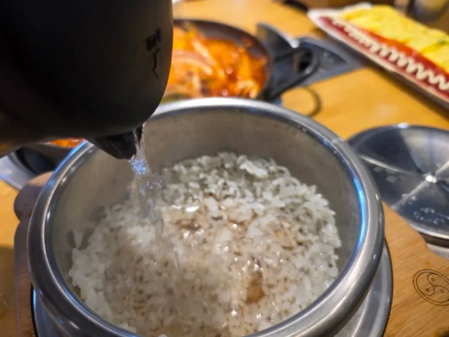 Glossy sotbap rice transferred to a bowl