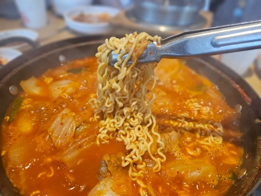 Ramen noodles soaked in kimchi jjigae broth