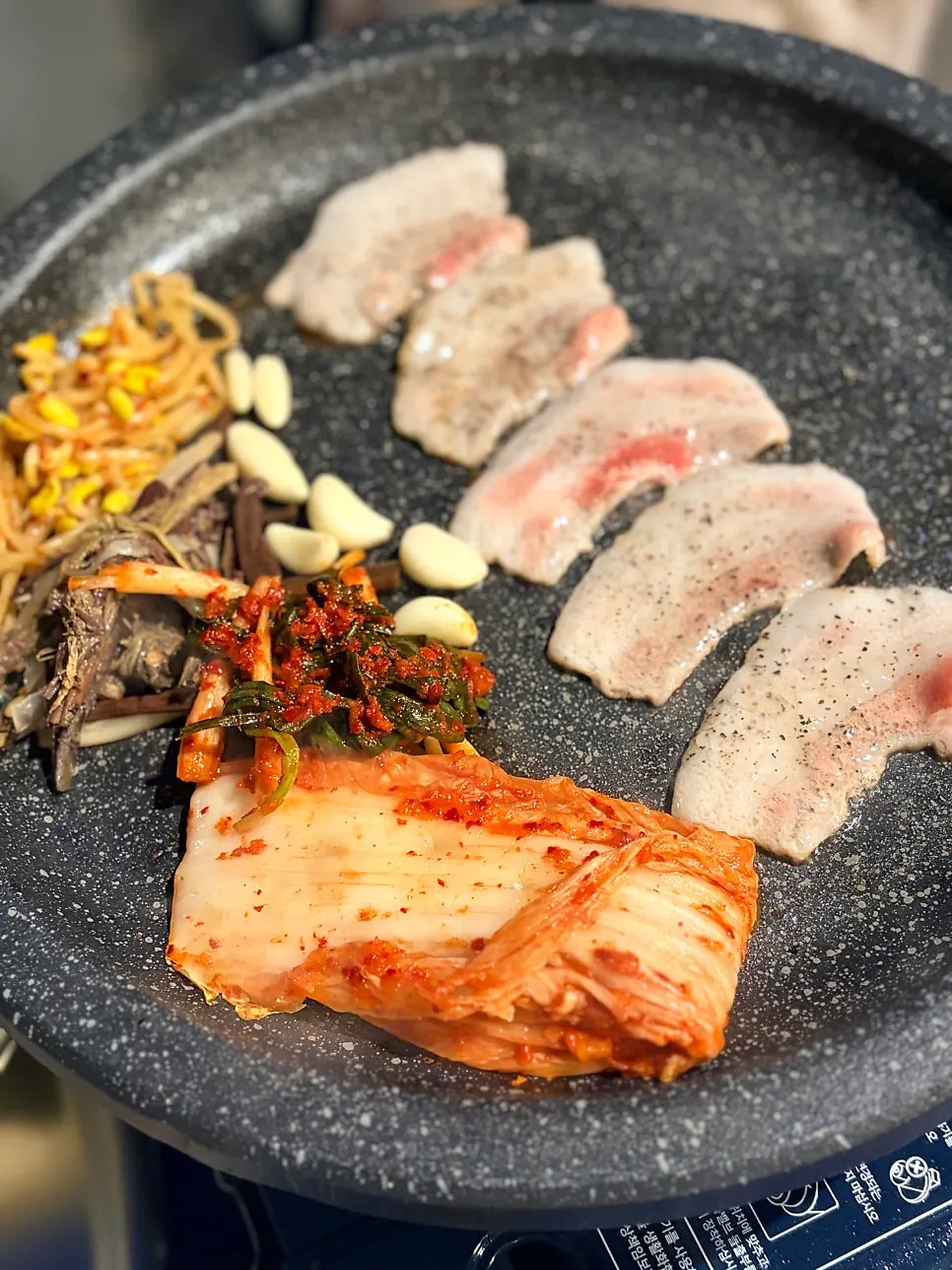 Kimchi, green onion kimchi, bean sprouts, and bracken fern on the grill