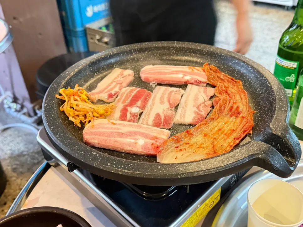 Kimchi grilled in a long strip on one side of the grill