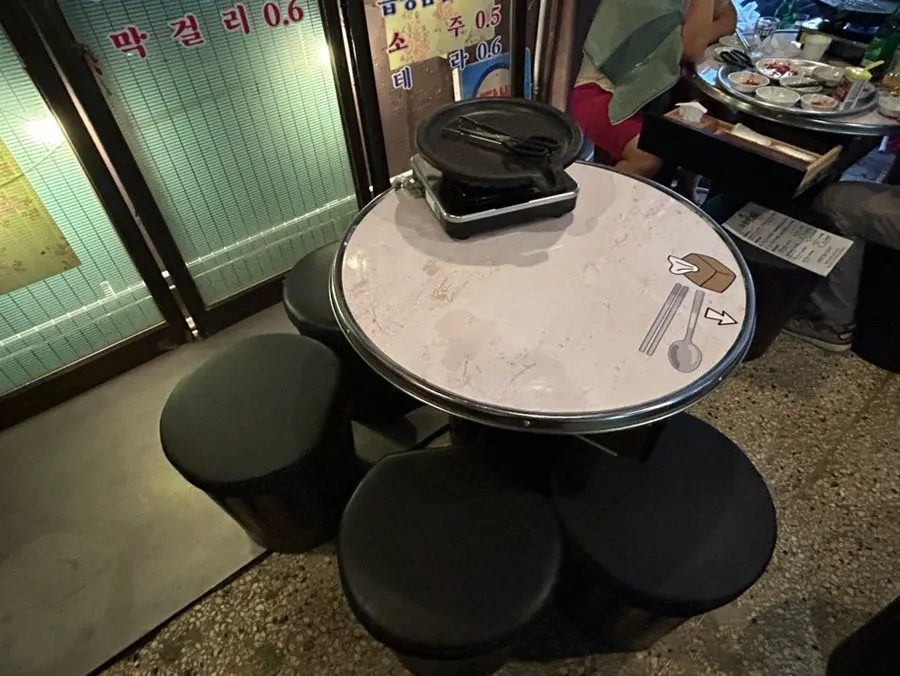 Seating area and grill setup at Chowon Restaurant Jongno 3-ga Branch