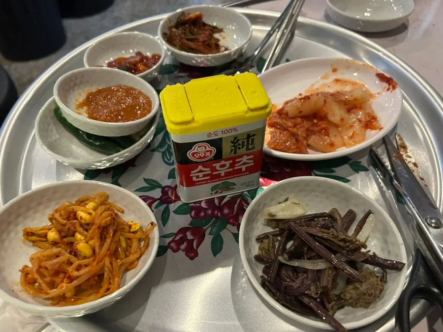 Side dishes including bean sprouts, bracken fern, and salted squid