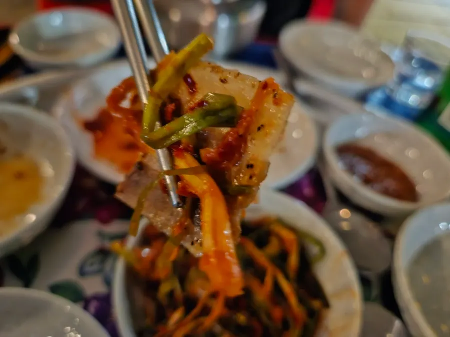 Well-cooked frozen pork belly served with banchan