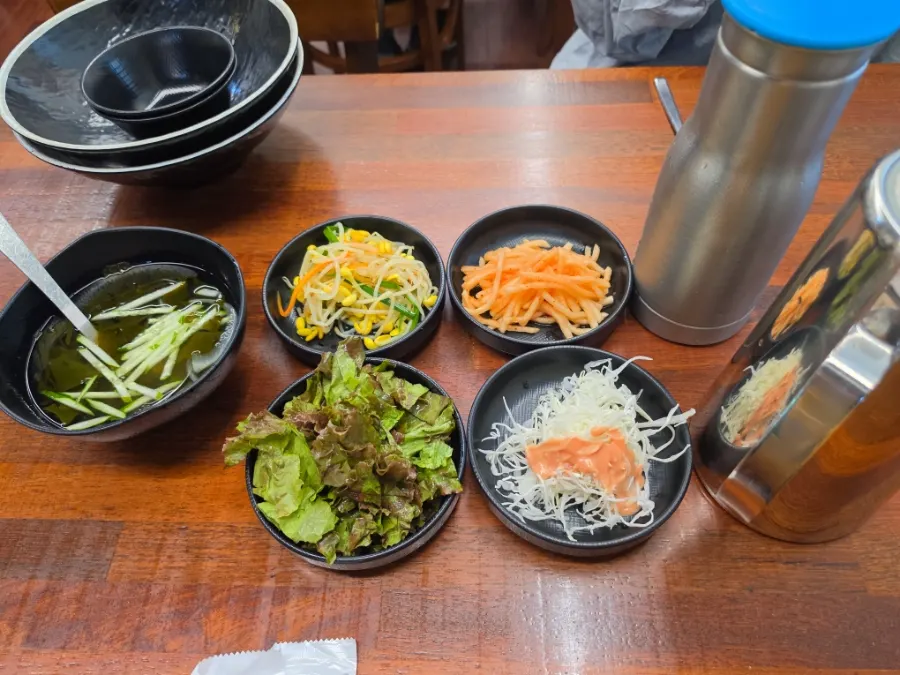 Table spread of side dishes served with the jjukkumi set