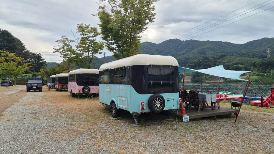 Table, ice box, and gas burner in front of the caravan