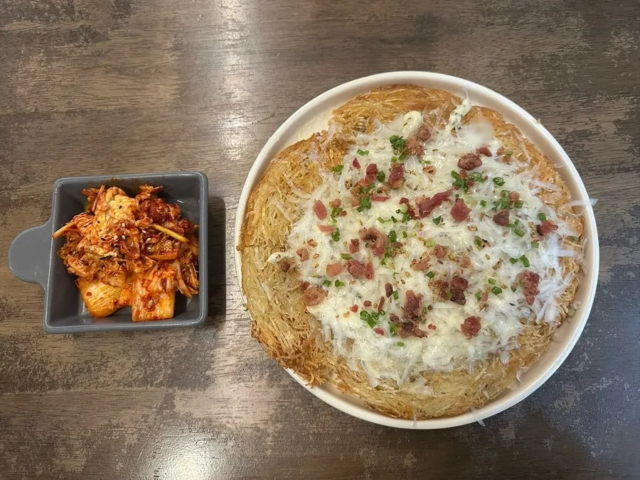 Hyeondae Memil bibim mak guksu topped with aged kimchi