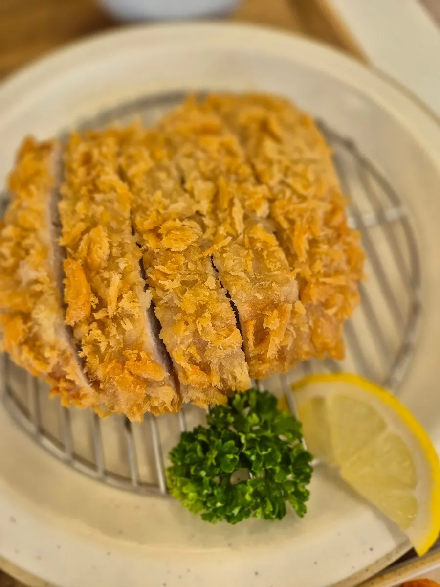 Golden, crispy loin cutlet set on a plate