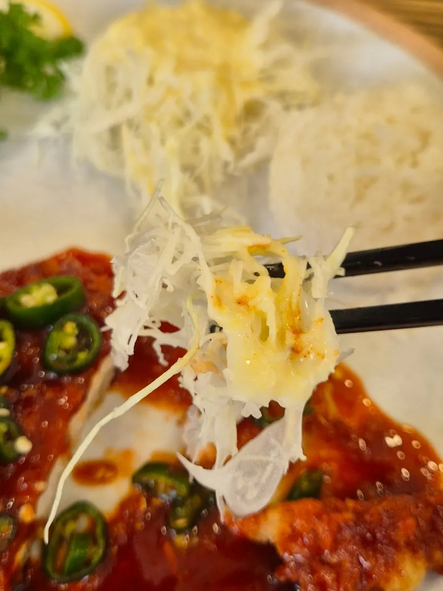 Picking up a piece of the spicy pork cutlet