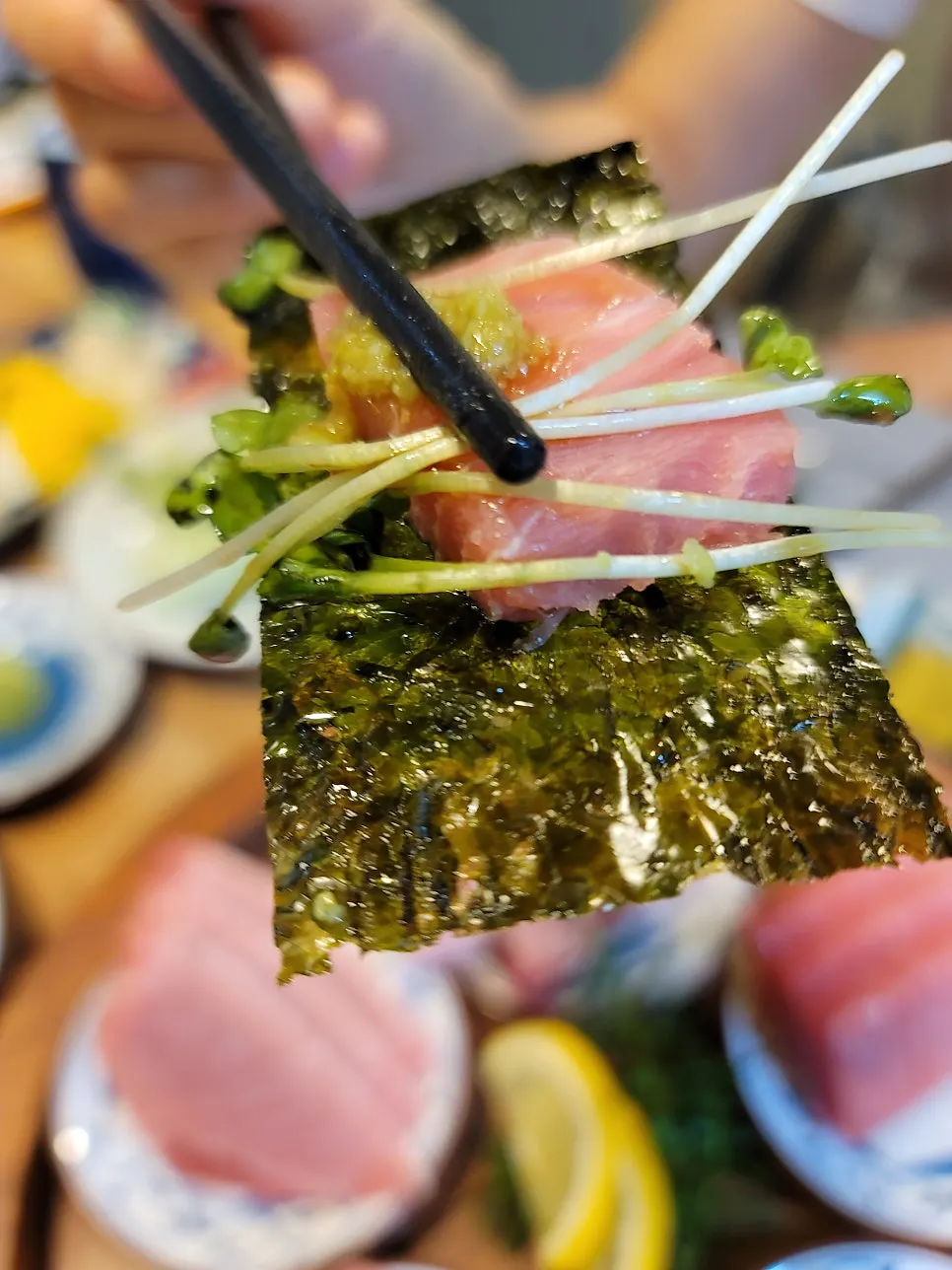 Picking up a piece of aged tuna sashimi