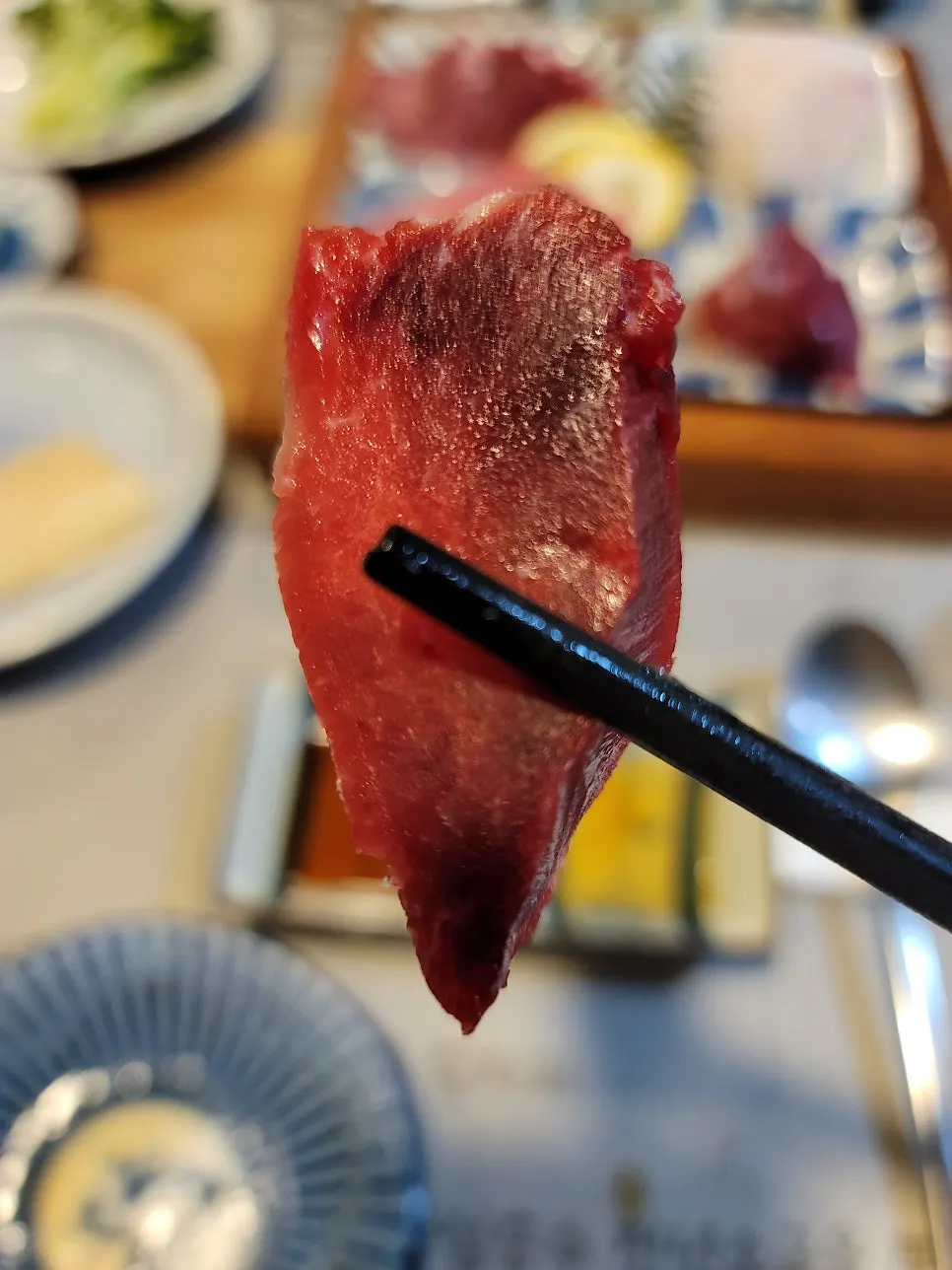 An additional plate of tuna sashimi continuing the course