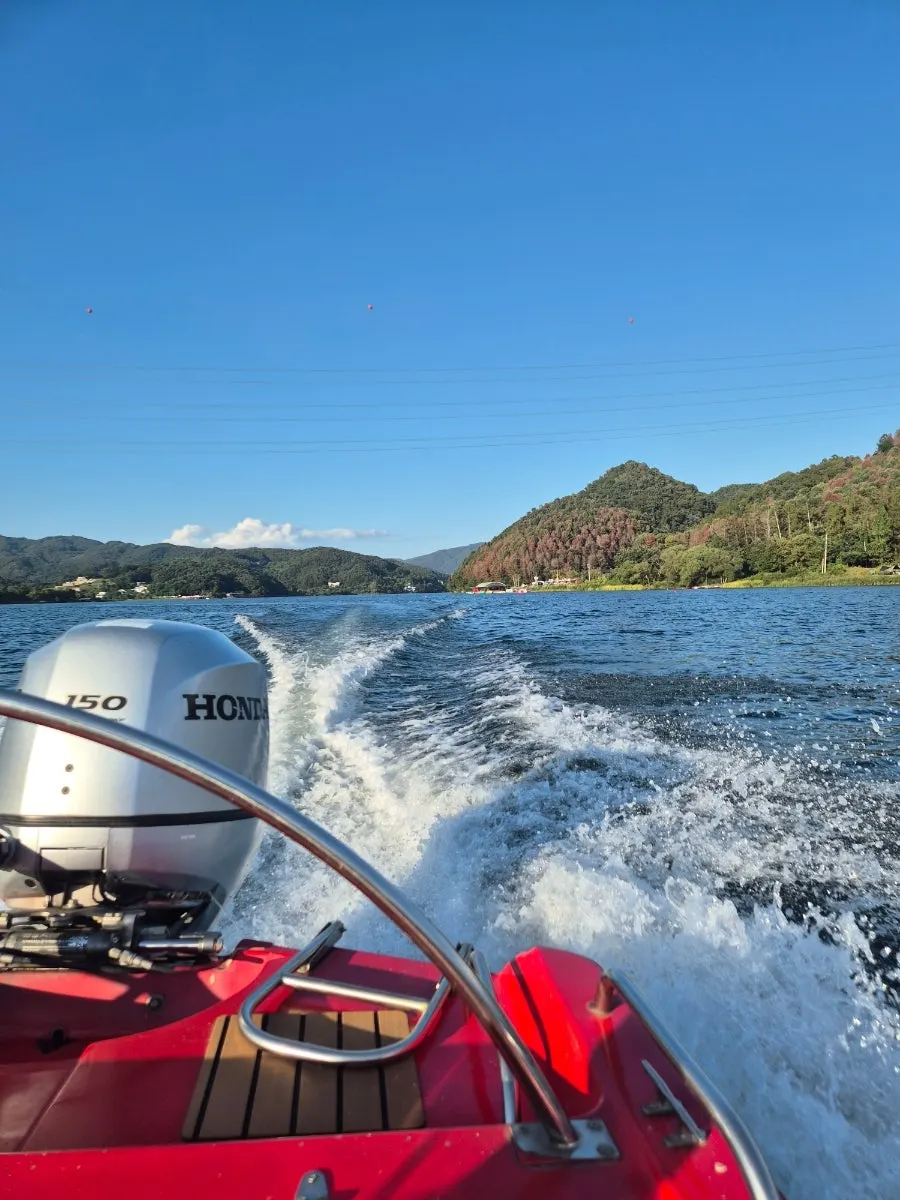 Motorboat speeding along with hair blowing in the wind
