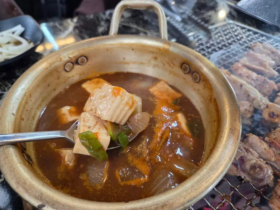 A piece of charcoal dakgalbi placed over white rice