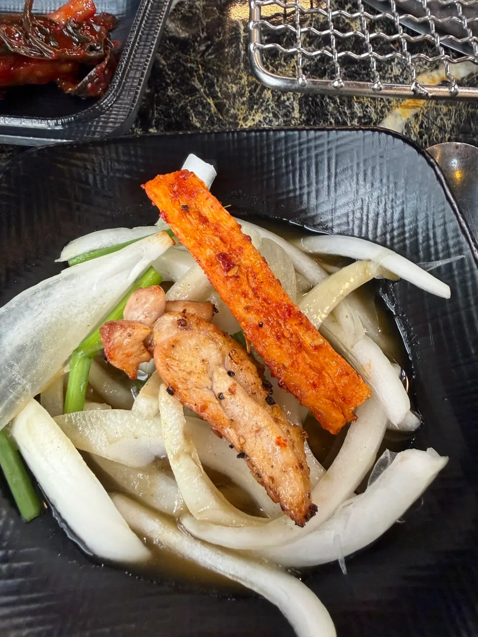 A grilled piece of salt dakgalbi