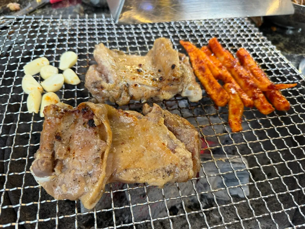 Soy dakgalbi grilling over charcoal