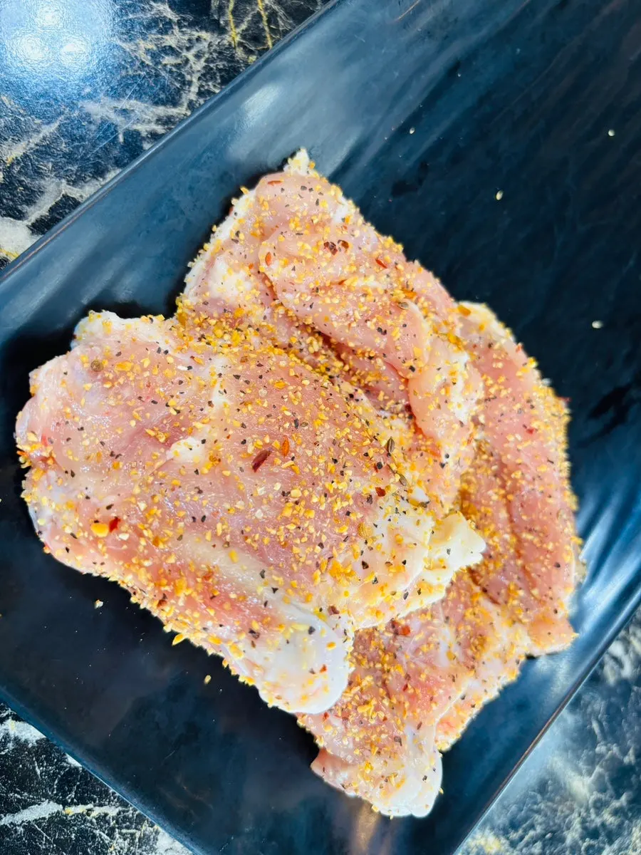 Charcoal-grilled dakgalbi cooking on the grill