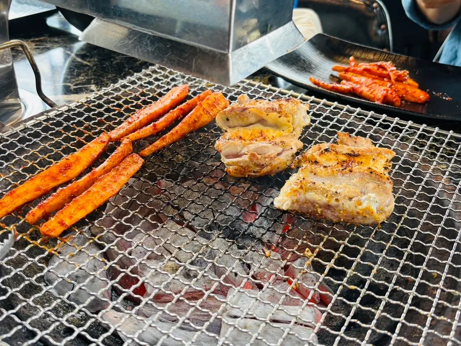 Dakgalbi and deodeok on the charcoal grill