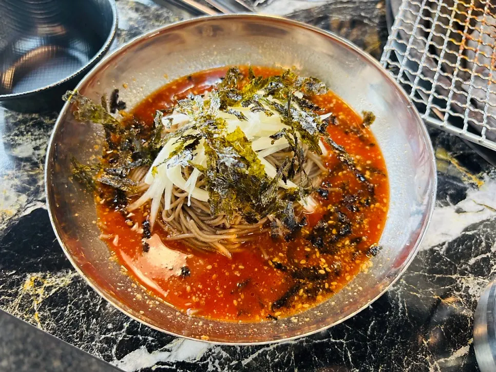A hearty charcoal grill full of dakgalbi and deodeok