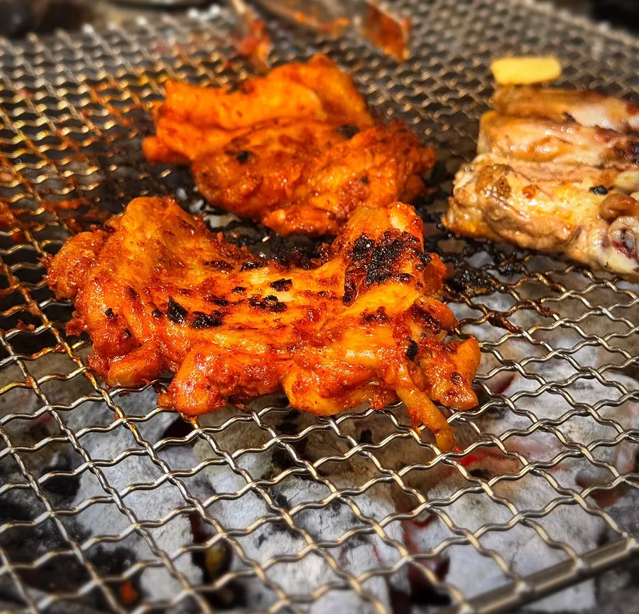 Gochujang dakgalbi grilling over charcoal