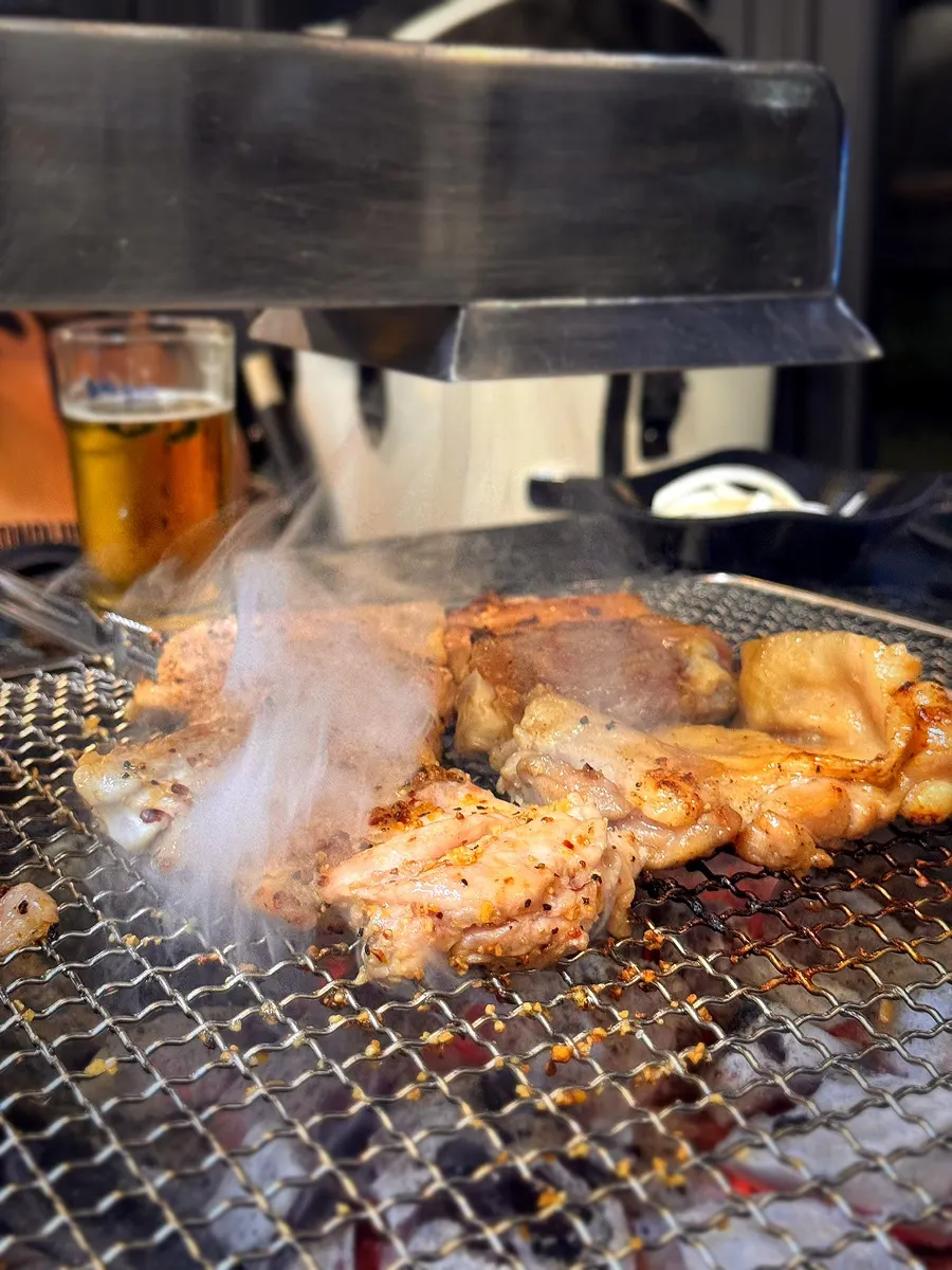 Table mid-meal enjoying charcoal dakgalbi