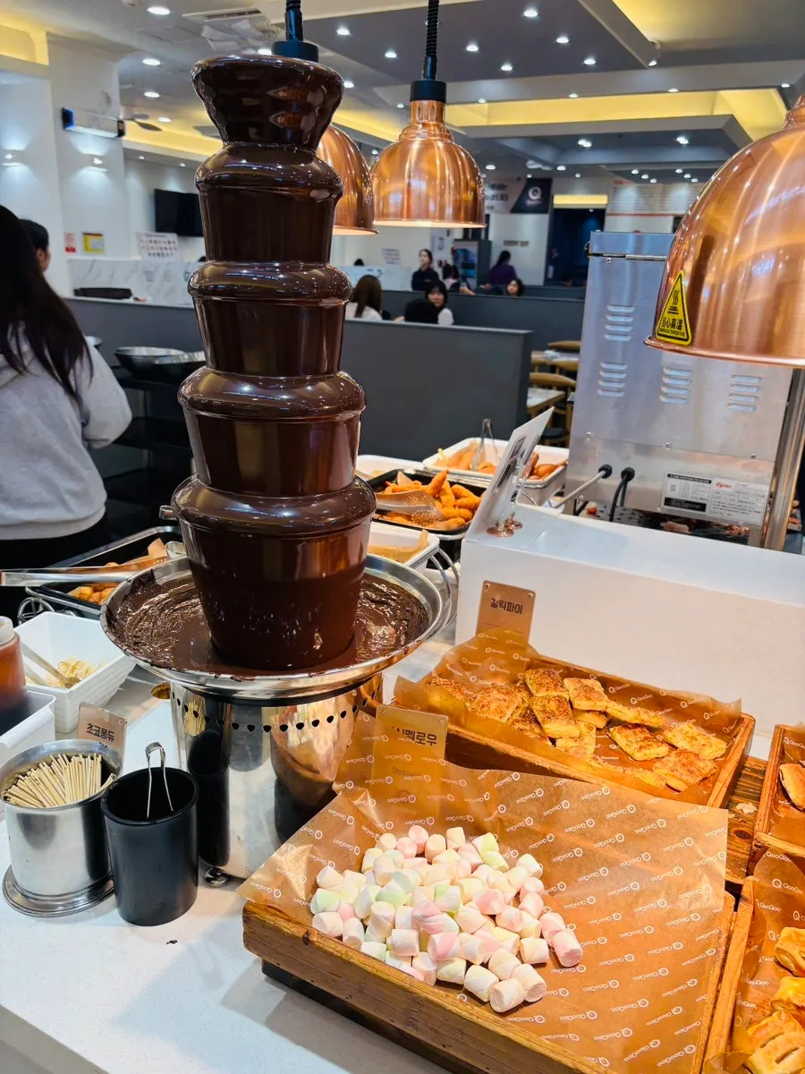A dessert plate with cake, bread, and fruit