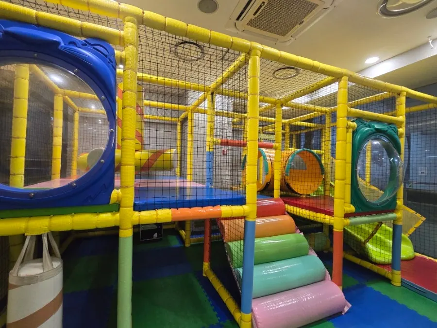 Interior of QooQoo Chuncheon Branch with partitioned seating and a kids' play area