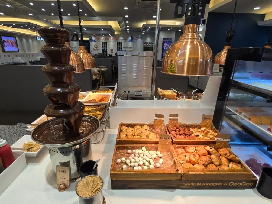 Dessert corner with fondue, cookies, and marshmallows