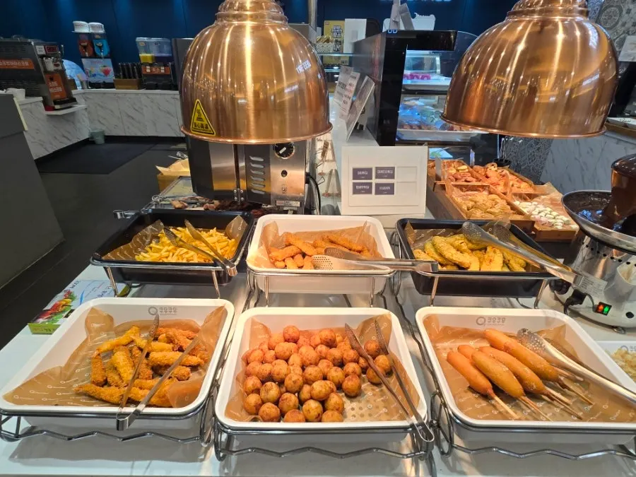 Corner with various fried foods and corn dogs