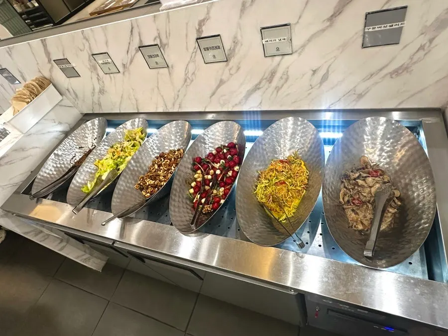 Station with salads and toppings