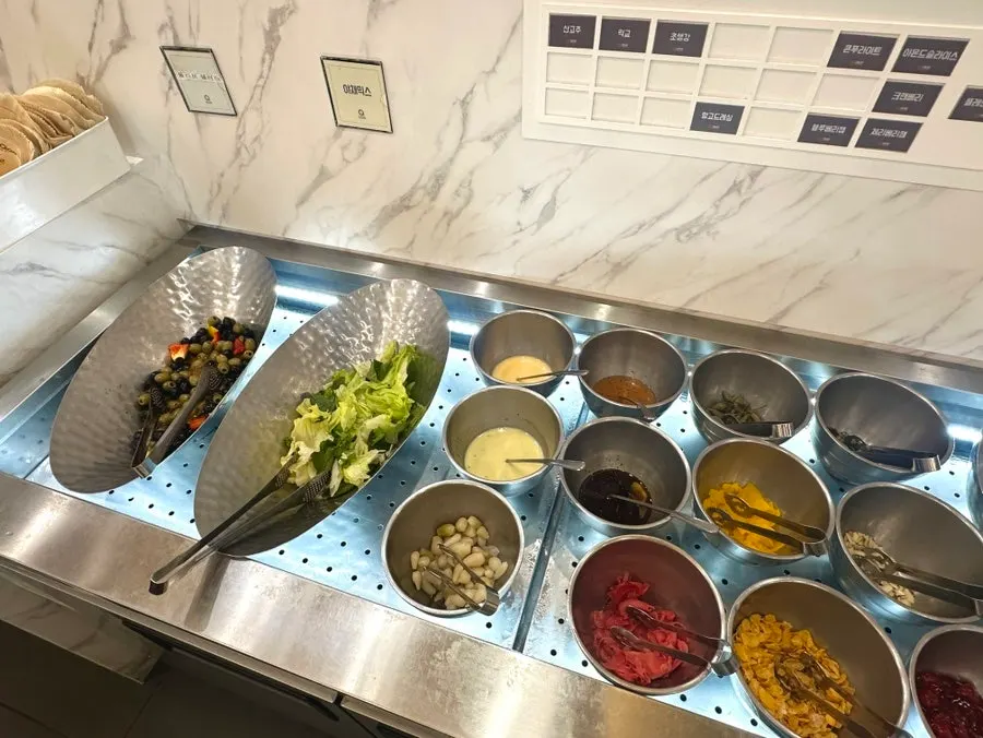 Buffet station lined with various sauces