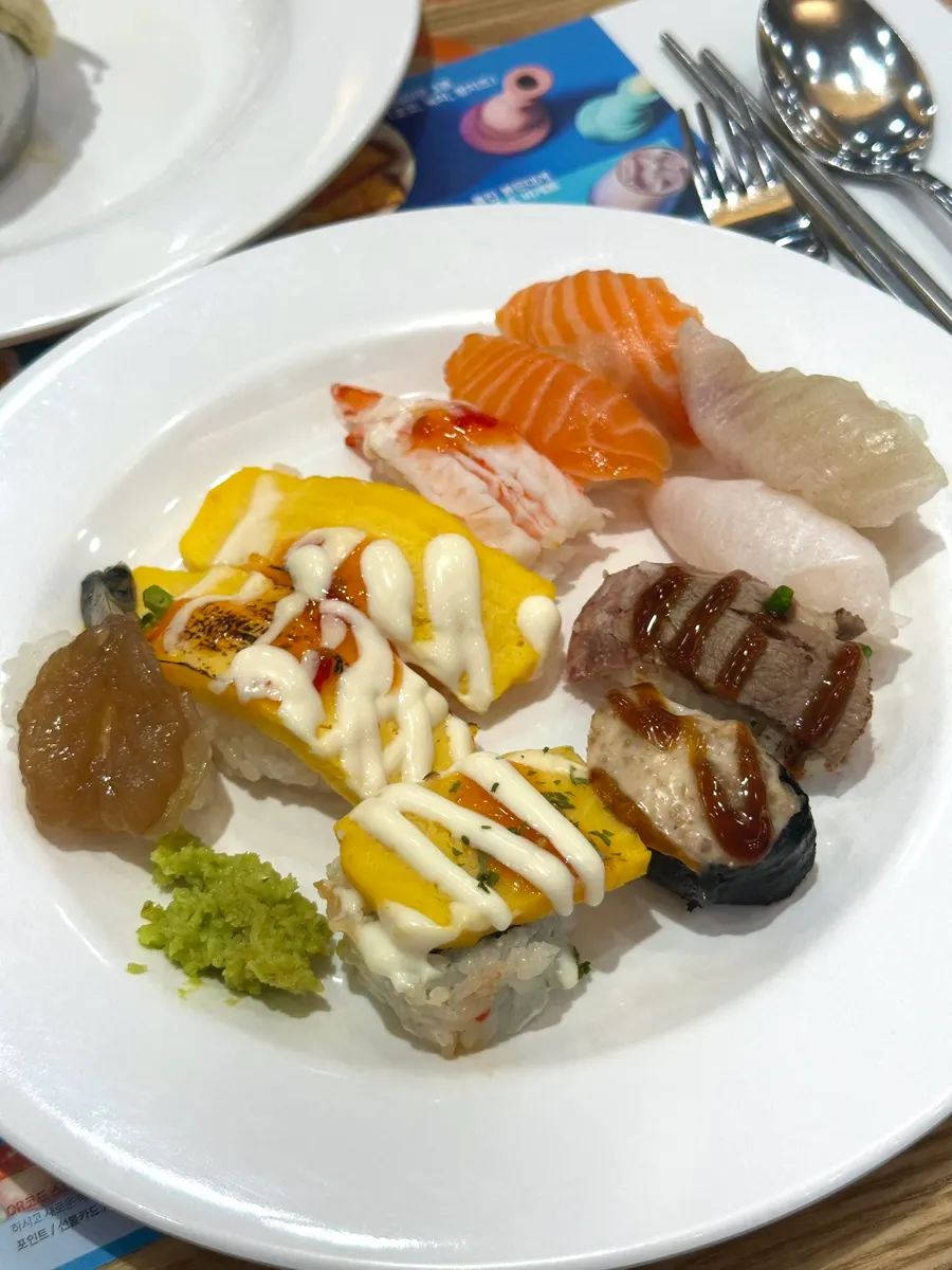 First plate loaded mostly with sushi