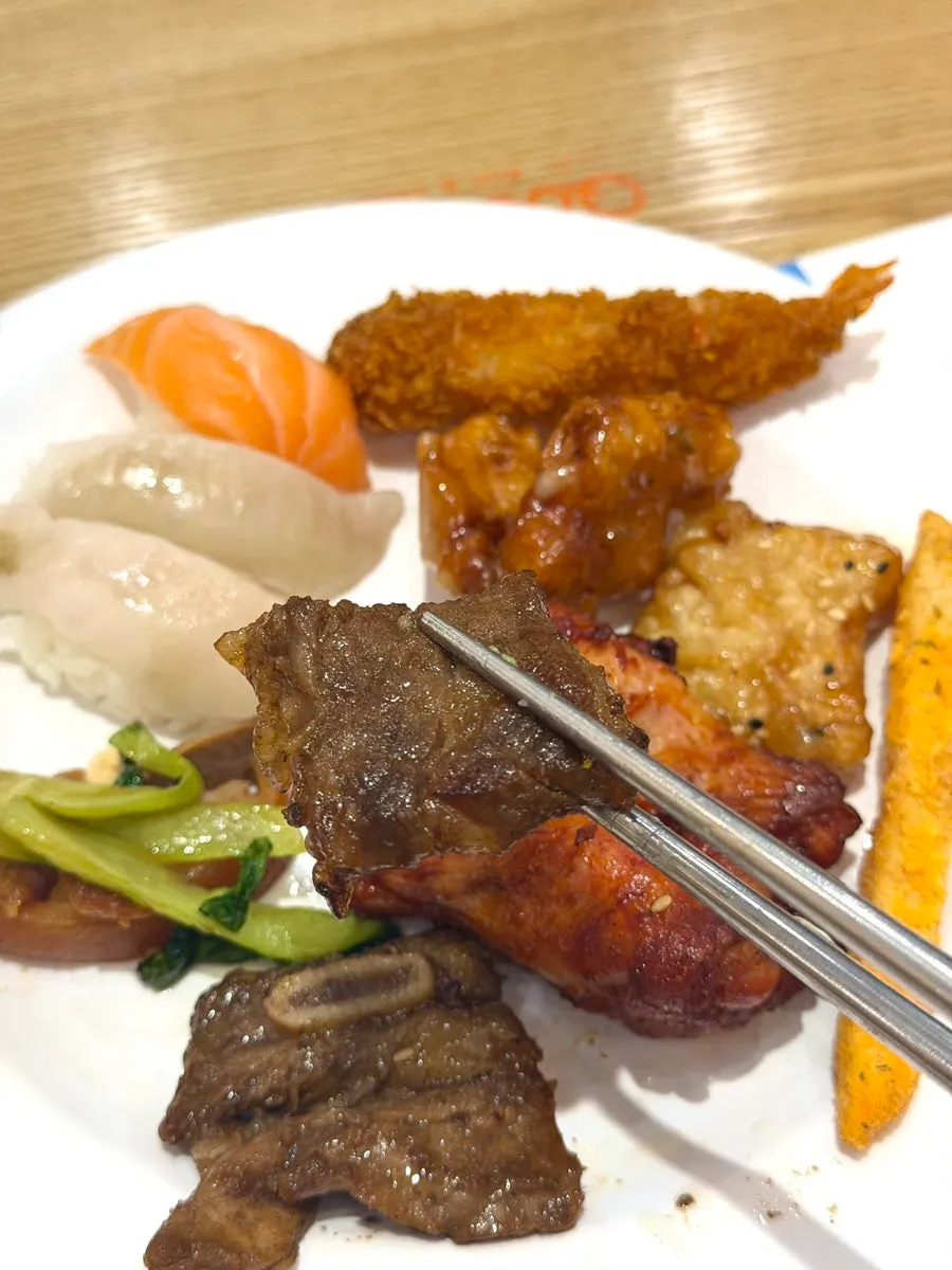 A plate with galbi and fried food