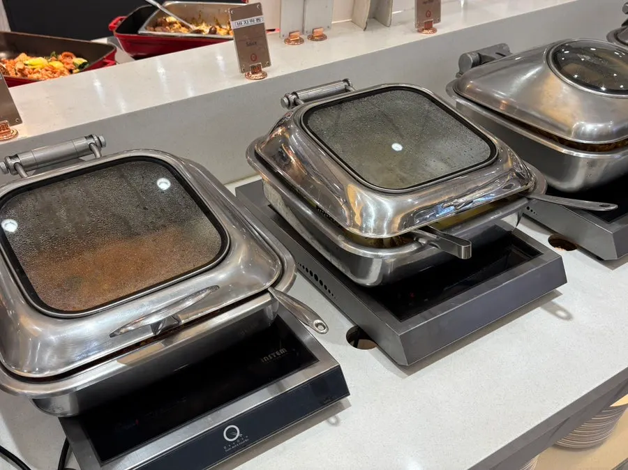 Buffet station with pasta, mala xiang guo, and more