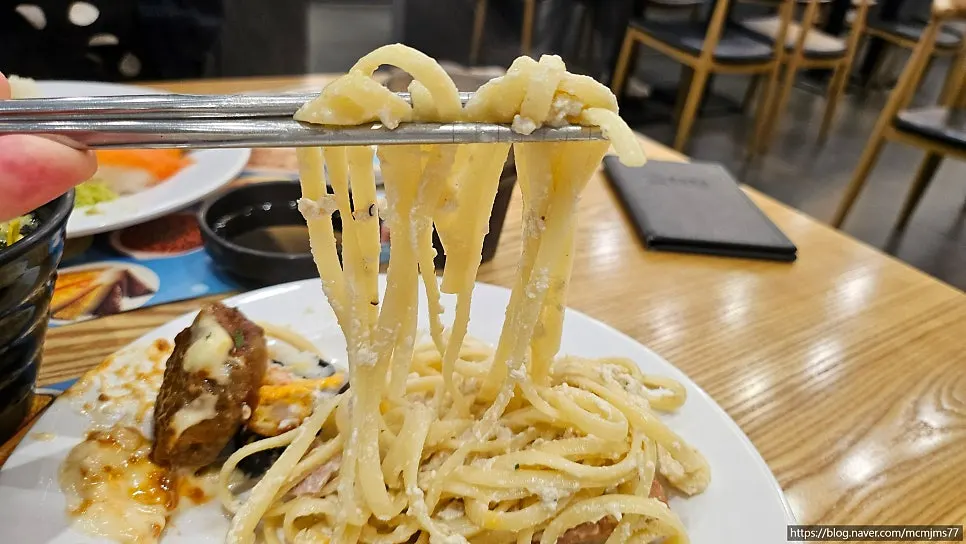 Plate of sushi, pasta and tempura brought to the table