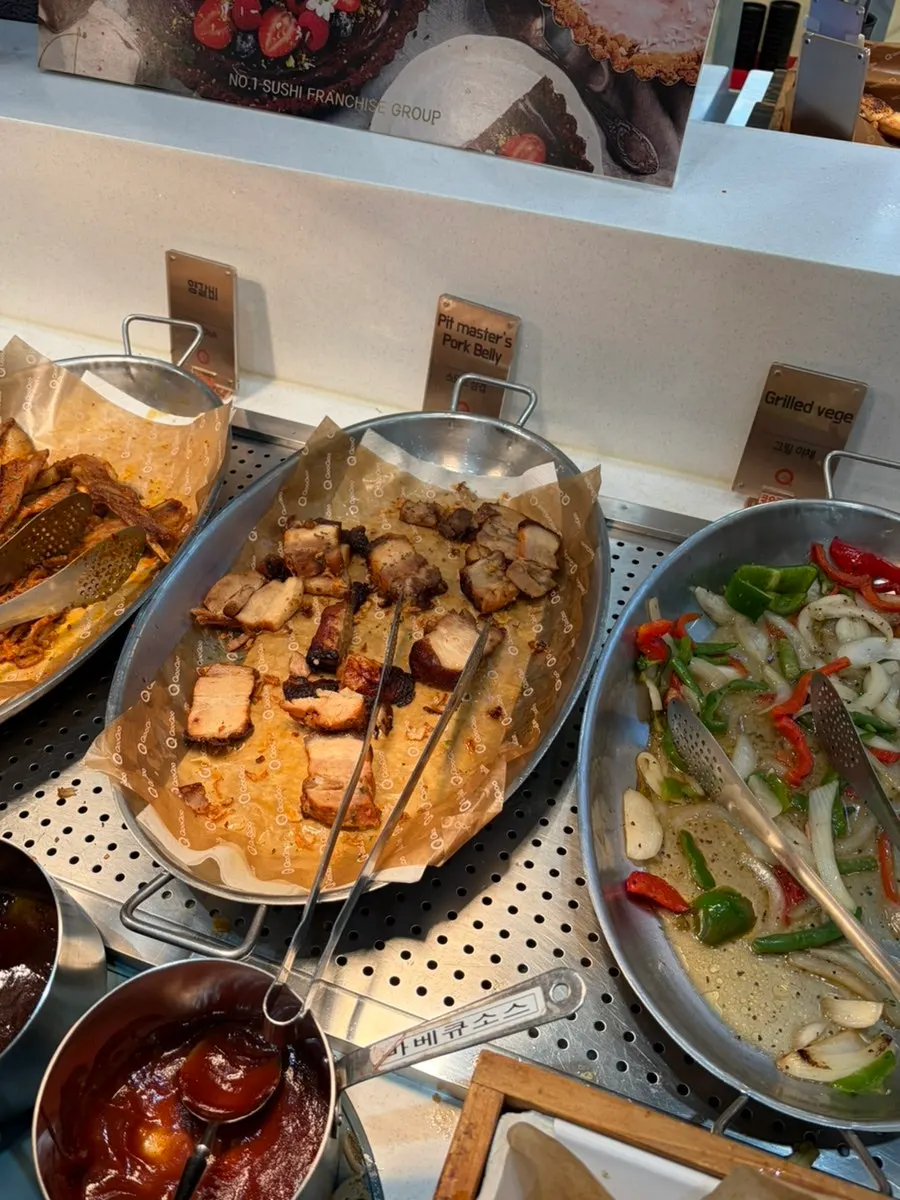 A plate with sushi and other buffet dishes