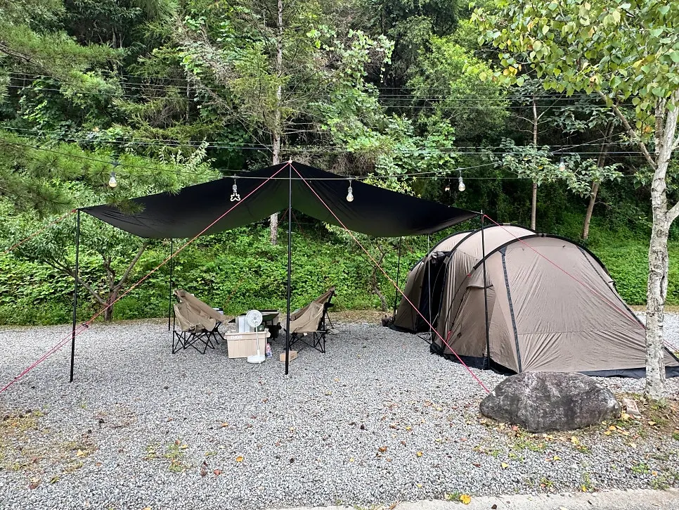 View of the camping site surrounded by the Bukhangang River and mountains
