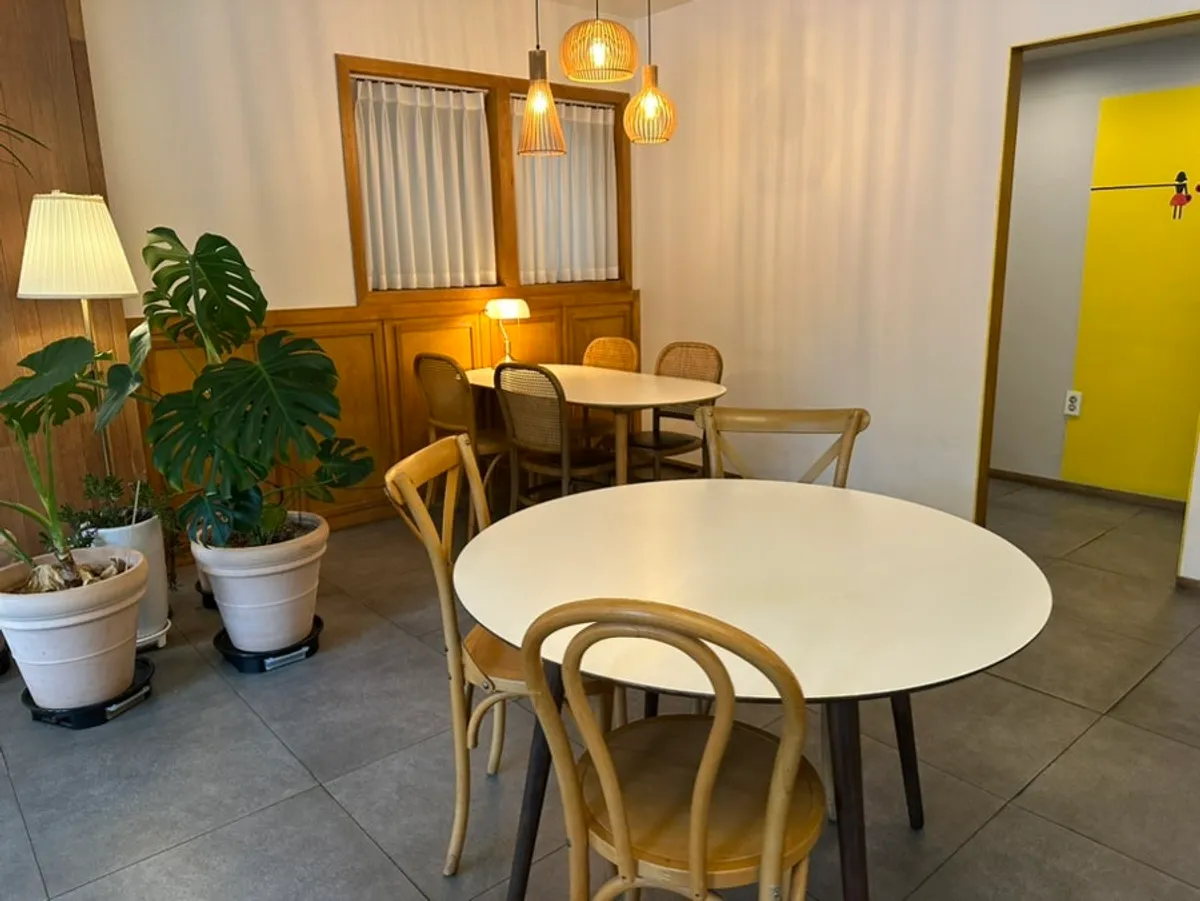 Café interior with dark wood-toned furniture and antique lighting