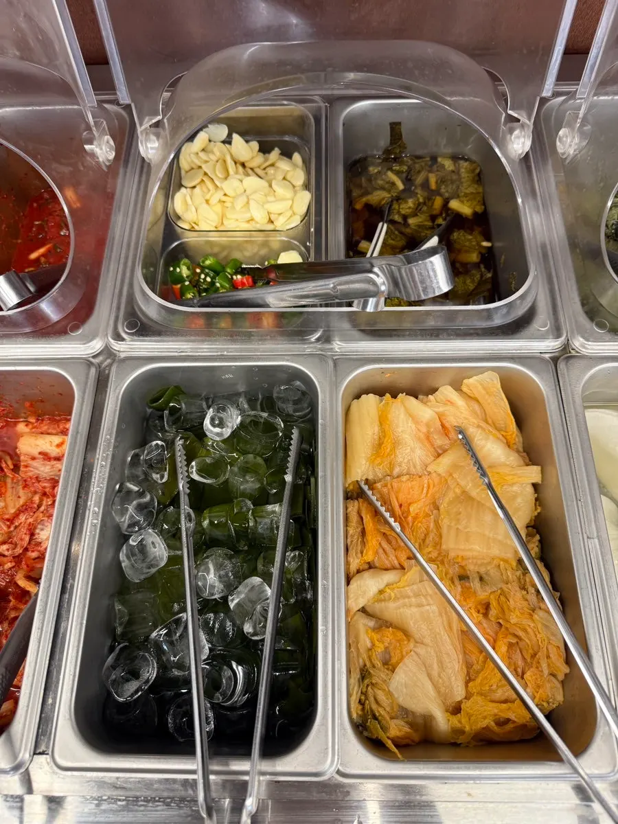 Side dish containers set out at the self-serve bar