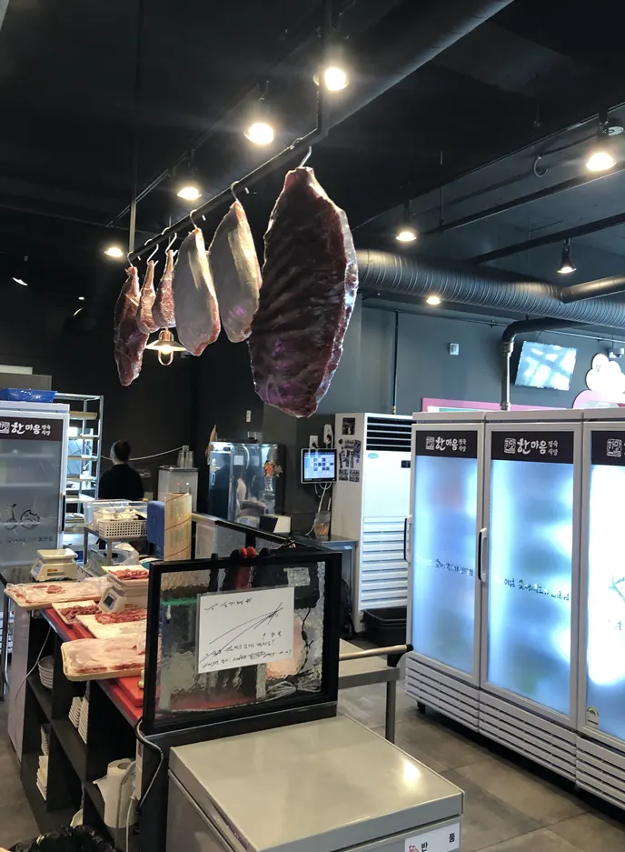 Aged meats hanging at the restaurant entrance
