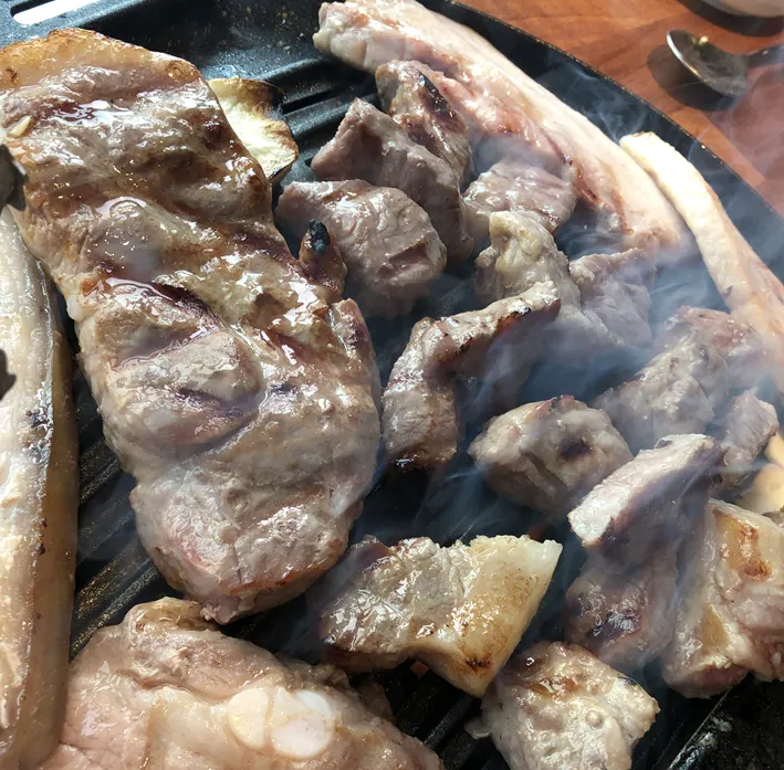 Thick pork neck grilling on the plate