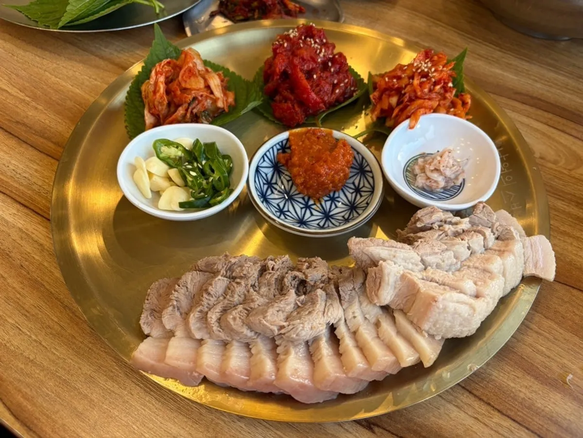 Pollock mak-guksu piled generously with pollock sashimi