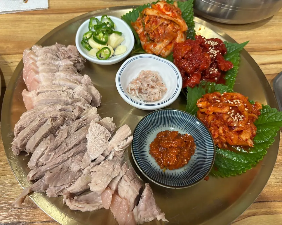 Bossam spread with an array of side dishes