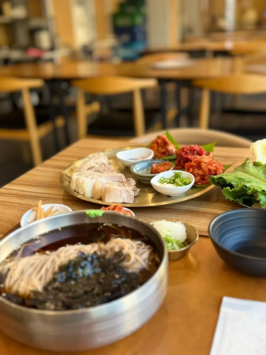 Kimchi, radish salad, and pollock sashimi side dishes