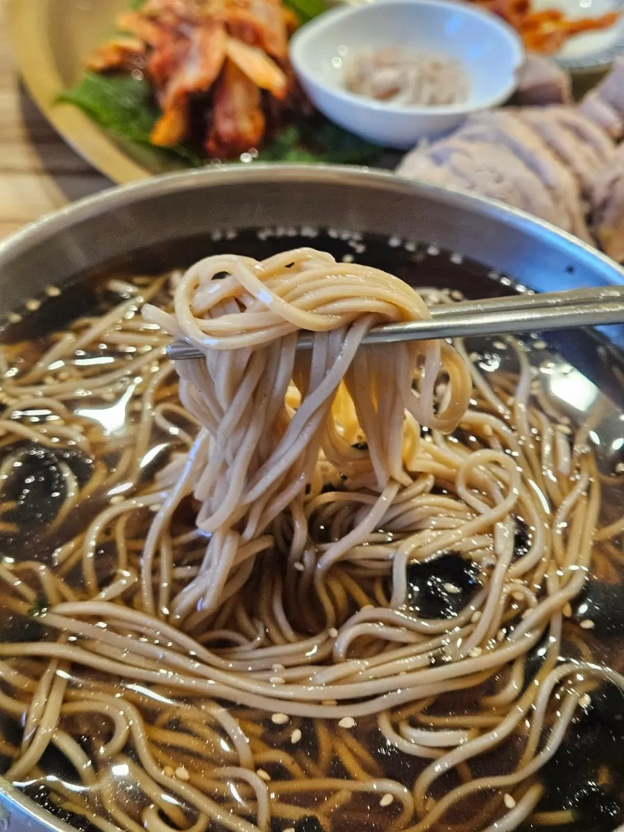 Lifting Jeonju-style soba noodles with chopsticks