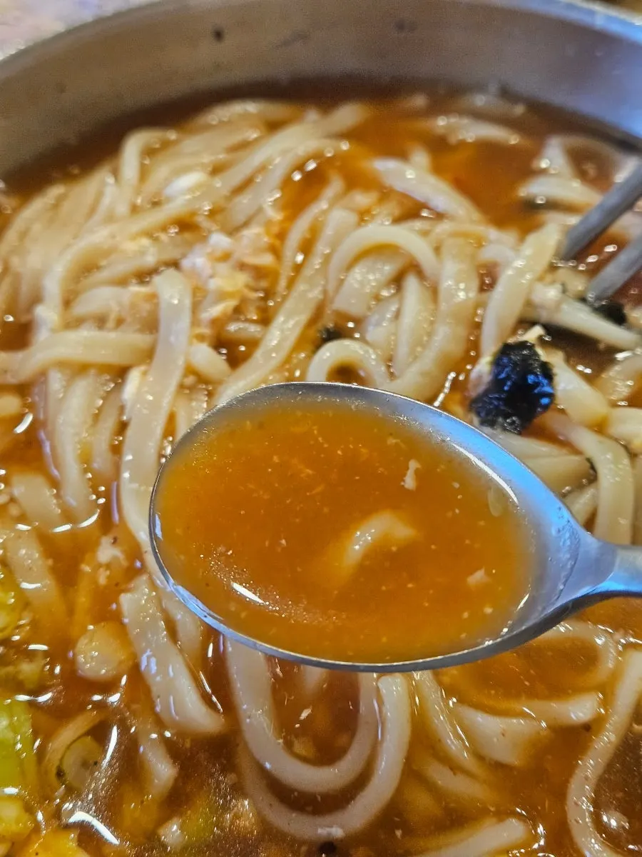 Jang kalguksu topped with egg and gim