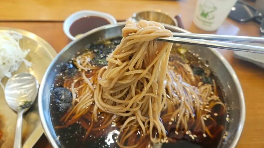 Springy buckwheat noodles lifted from the bowl